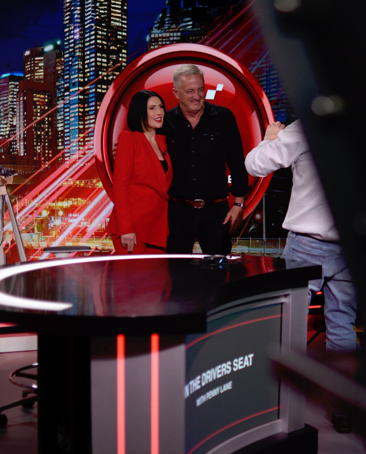 On set with the In the Driver's Seat desk branding